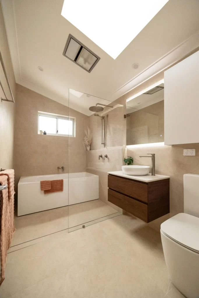 bathroom renovations sydney- a bathroom with a glass shower door