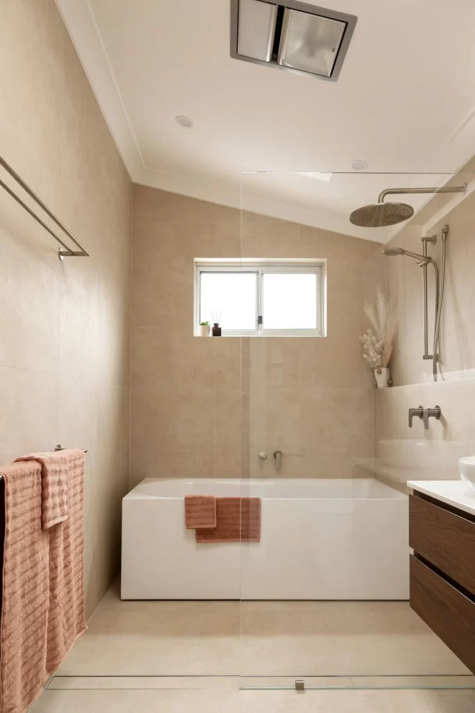 Bathroom Renovation- a bathroom with a glass shower and bathtub