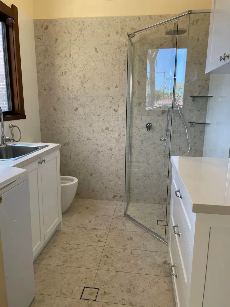bathroom renovations near me- a bathroom with a glass shower and sink