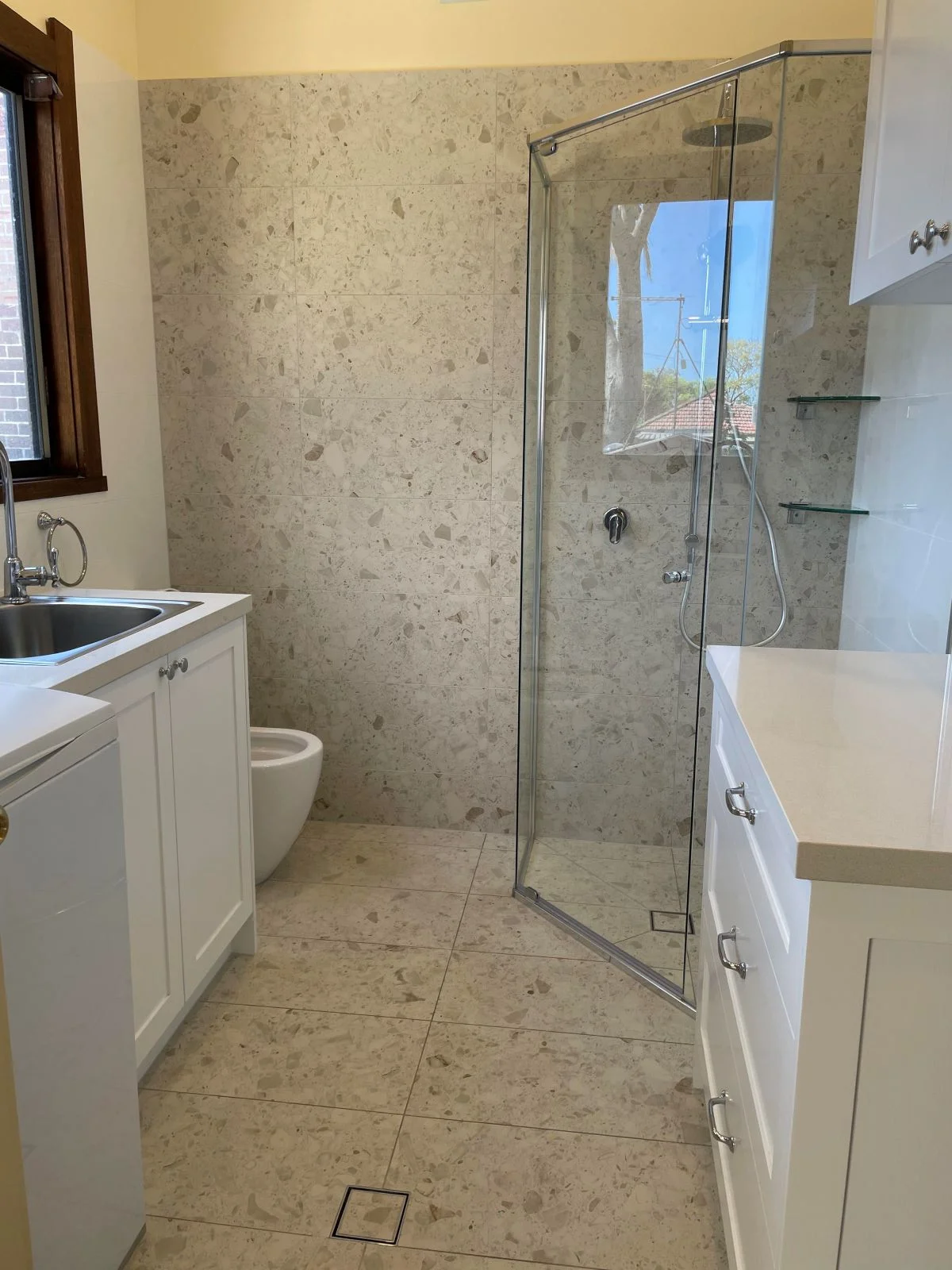 bathroom renovations near me- a bathroom with a glass shower and sink