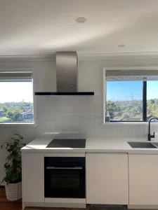 kitchen renovations- a kitchen with white cabinets and a black stove