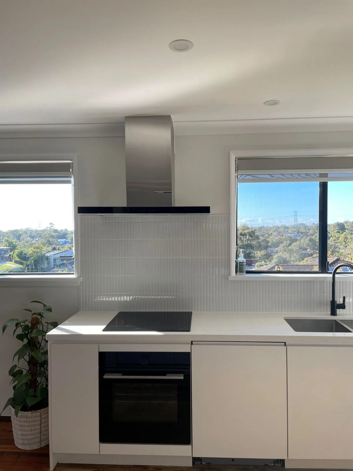kitchen renovations- a kitchen with white cabinets and a black stove