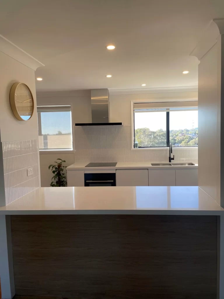 kitchen renovations- a kitchen with a white countertop and a white sink