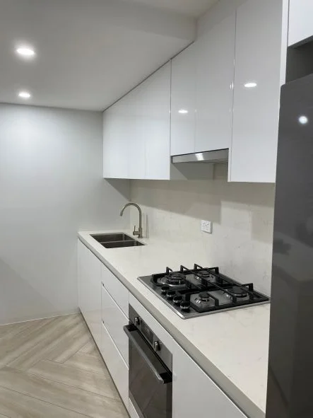 kitchen renovations- a kitchen with white cabinets and a stove